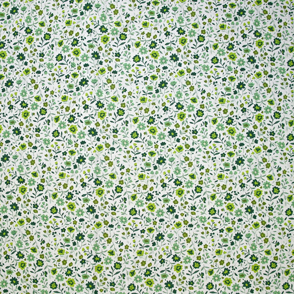 Coton imprimé ouragan floral vert fond blanc