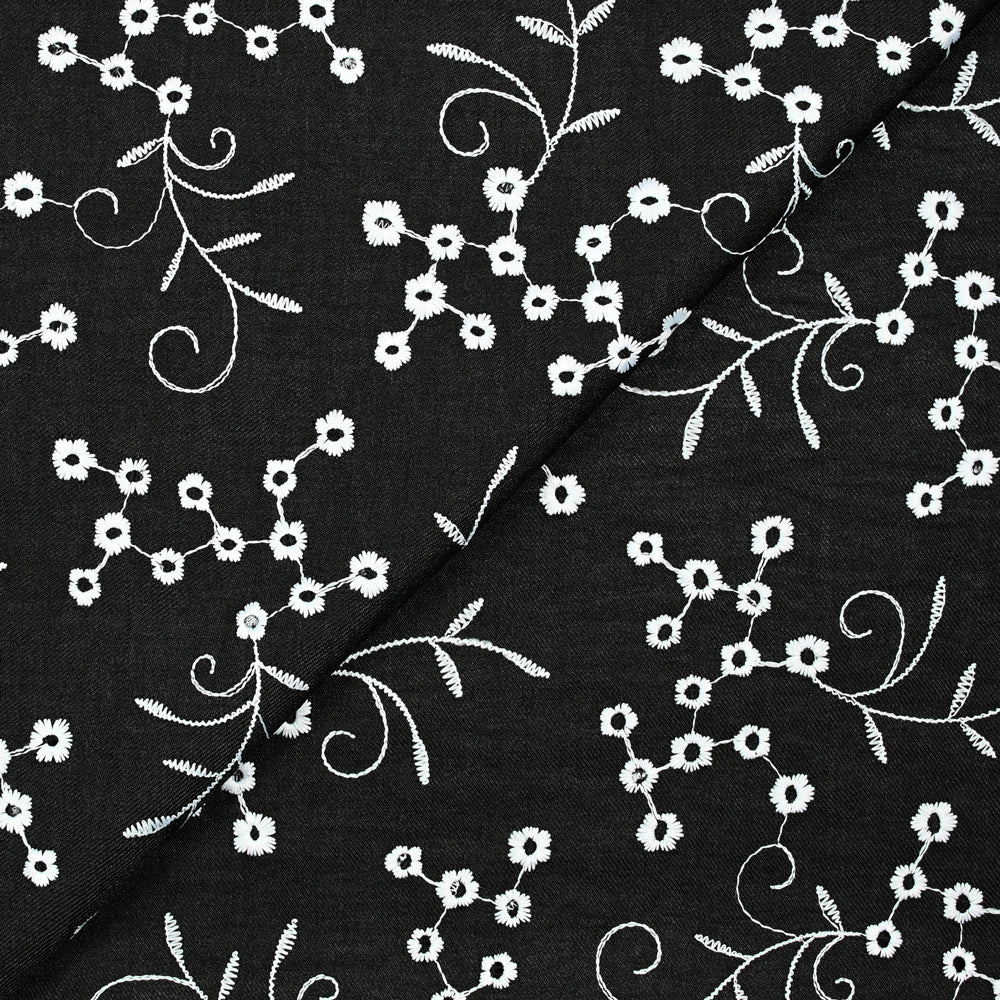 Twill de polyester brodé marguerite fond noir